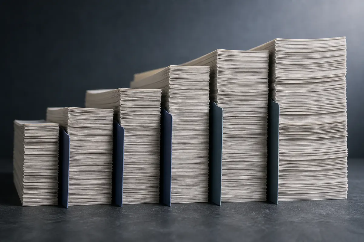Six stacks of paper of different heights, separated by dark index dividers